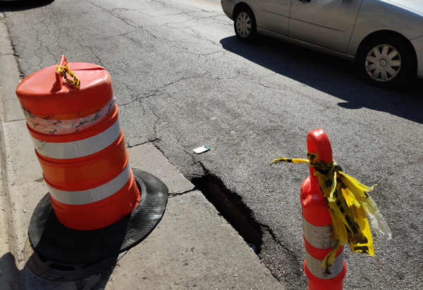 Bike cop injured when wheel drops into unmarked pothole