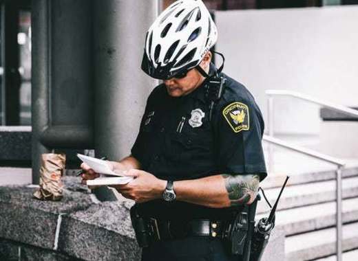 Policemen on their own bikes monitor the scooter traffic in Helsinki