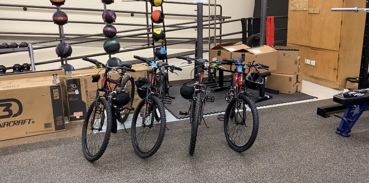 Spokane Police Officers, high school students assemble bicycles for local kids
